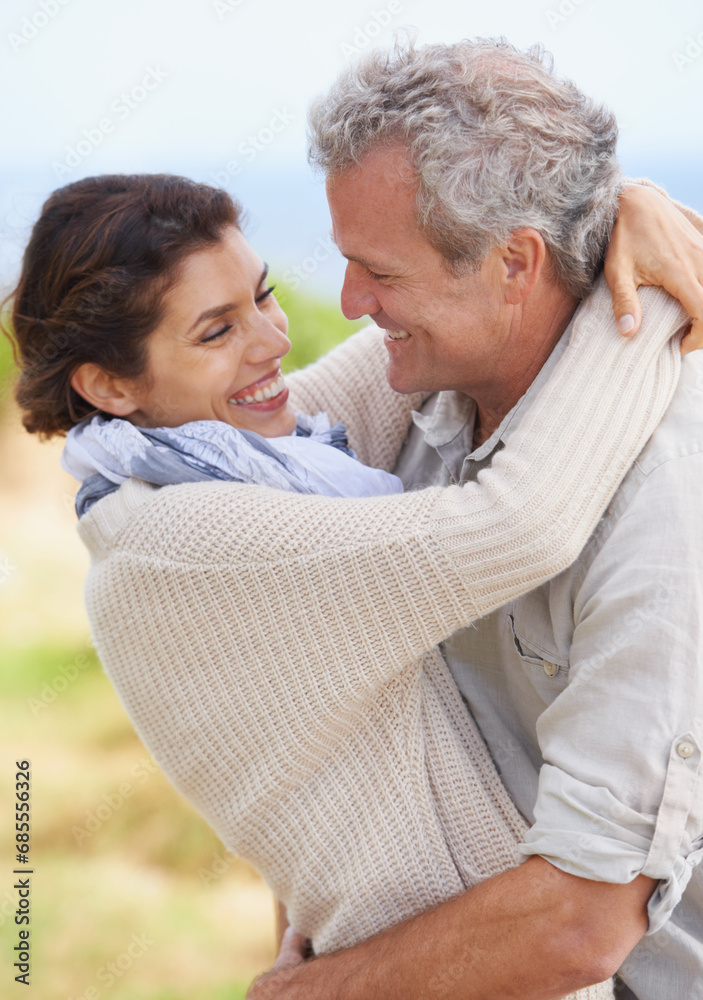 Couple, face and laughing in nature with hug for romance, love and relationship outdoor with date. Mature, man and woman or embrace with happy, playful or marriage for bonding, honeymoon and support Couple, face and laughing in nature with hug for romance, love and relationship outdoor with date. Mature, man and woman or embrace with happy, playful or marriage for bonding, honeymoon and support