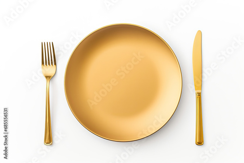 top view an empty plate with gold spoon fork and knife isolated on white background photo
