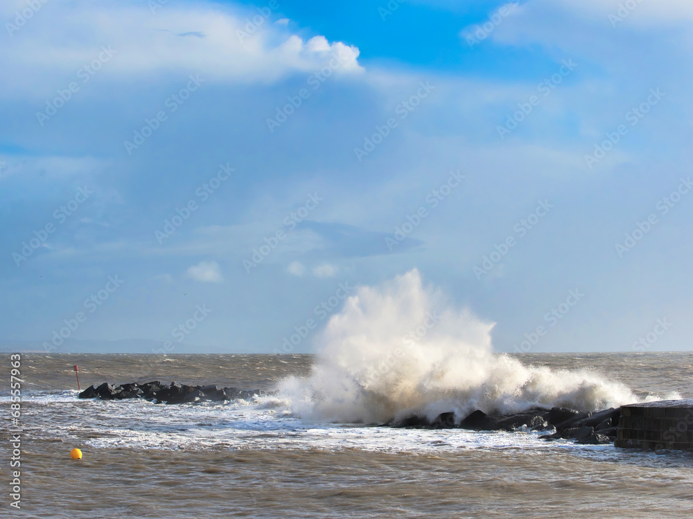 Stormy waves crashing over the Cobb seawall at Lyme Regis at the tail end of Storm Ciarán