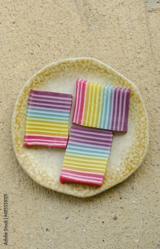 Layered and colorful cake slices with top angle view. Traditional cake made from rice flour and coconut milk. Kue lapis