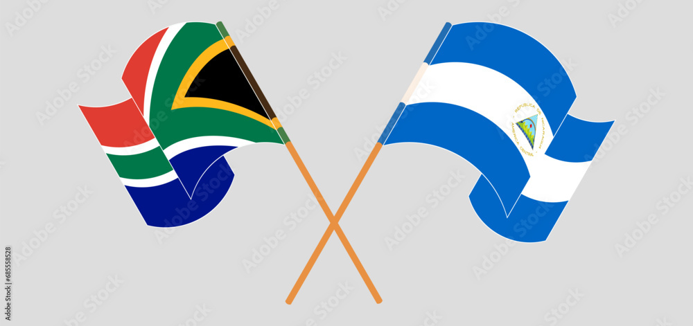 Crossed and waving flags of South Africa and Nicaragua
