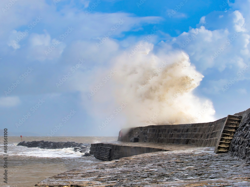 Stormy waves crashing over the Cobb seawall at Lyme Regis at the tail end of Storm Ciarán