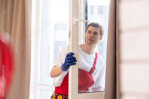 A repairman fixing windows in new apartment.