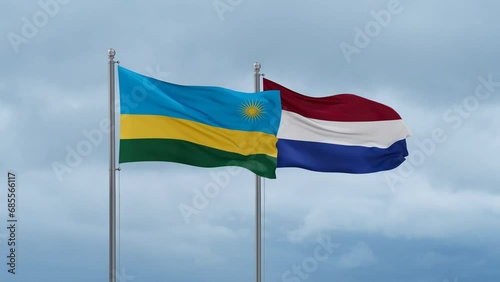 Netherlands flag and Rwanda flag waving together on cloudy sky, endless seamless loop, two country relations concept photo