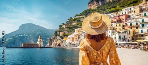 Tourist girl admires stunning Amalfi Coast in Italy copy space image photo