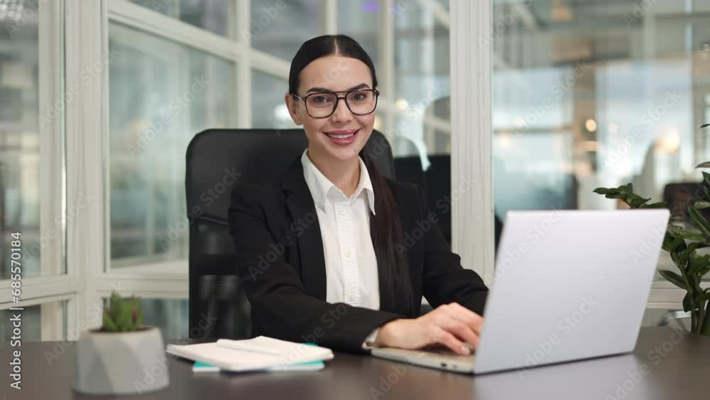 Confident woman freelancer with braided hair typing text on modern laptop keyboard while smiling in office. Caucasian business lady sitting at table and using device for high-quality work indoor. Confident woman freelancer with braided hair typing text on modern laptop keyboard while smiling in office. Caucasian business lady sitting at table and using device for high-quality work indoor.