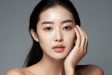 Beauty Display: Asian Female Model Exhibiting Skin Product
