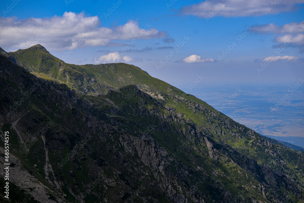 High and rocky mountains in the summer season. Landscape with the wild Carpathians of Romania