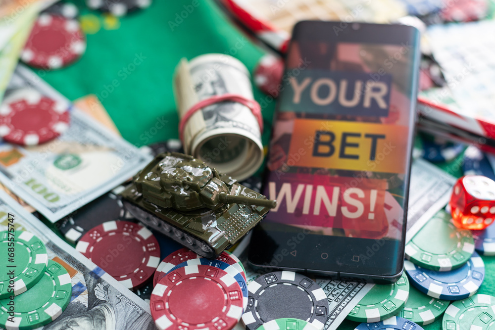 Mobile phone with bets, cards, chips, cubes and money dollars. Concept application for smartphone gambling, electronic casino online Mobile phone with bets, cards, chips, cubes and money dollars. Concept application for smartphone gambling, electronic casino online