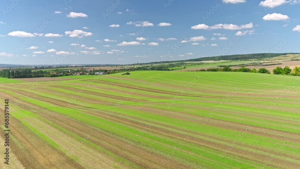 Machines till the fields for the coming harvest year. Wide angle drone shot. Machines till the fields for the coming harvest year. Wide angle drone shot.