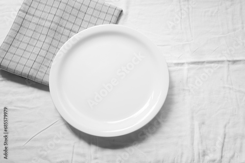 Empty white dish on napkin with space for your design.