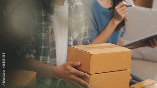 Wallpaper Mural Startup small business SME, Entrepreneur owner using smartphone or tablet taking receive and checking online purchase shopping order to preparing pack product box. Selling online ideas concept Torontodigital.ca