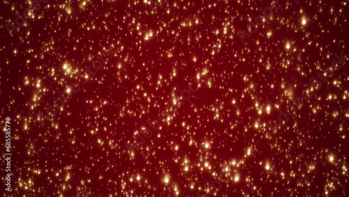 Looping animated christmas background of golden light particles falling on red background
