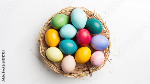 Colorful Easter eggs in the basket on the white background top view. Stylish spring template with space for text. Greeting card or banner