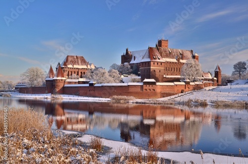 Malbork castle in Pomerania region of Poland. UNESCO World Heritage Site. Teutonic Knights' fortress also known as Marienburg. Nogat river at winter time 2023
 photo