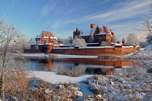Malbork castle in Pomerania region of Poland. UNESCO World Heritage Site. Teutonic Knights' fortress also known as Marienburg. Nogat river at winter time 2023
 photo