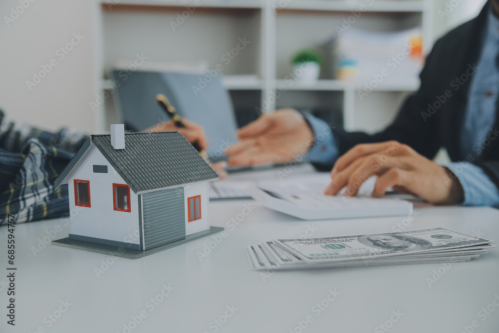 Fototapeta premium Real estate agent and customer signing contract to buy house, insurance or loan real estate.rent a house,get insurance or loan real estate or property.