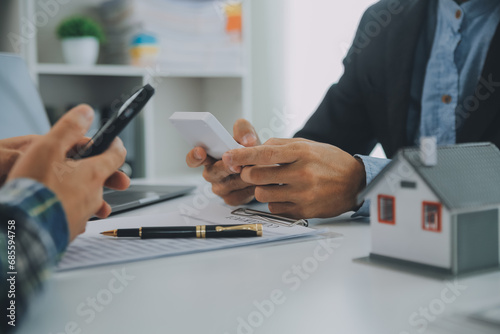 Foto Real estate agent and customer signing contract to buy house, insurance or loan real estate