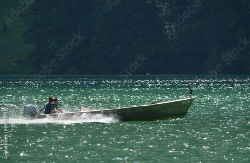 Two men in a motorboat sailing on the lake
