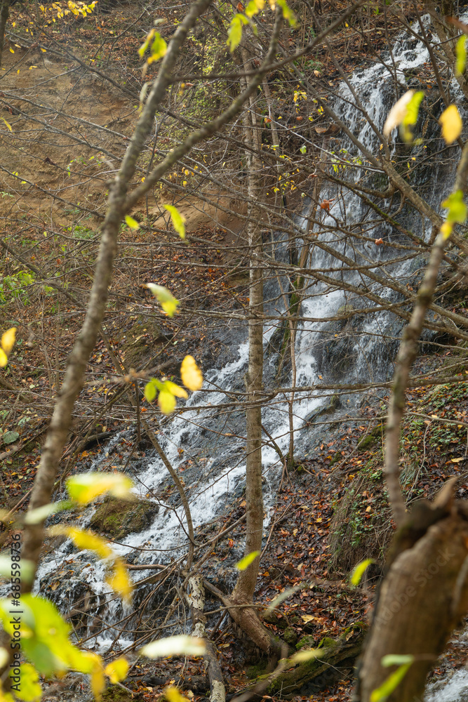 Beautiful view of small waterfall in autumn forest. Beautiful view of small waterfall in autumn forest.