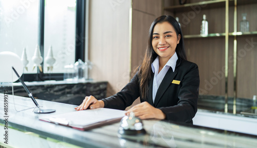 Beautiful asian hotel receptionist in uniforms at desk in lobby Friendly and welcome staff in hotel reception counter.