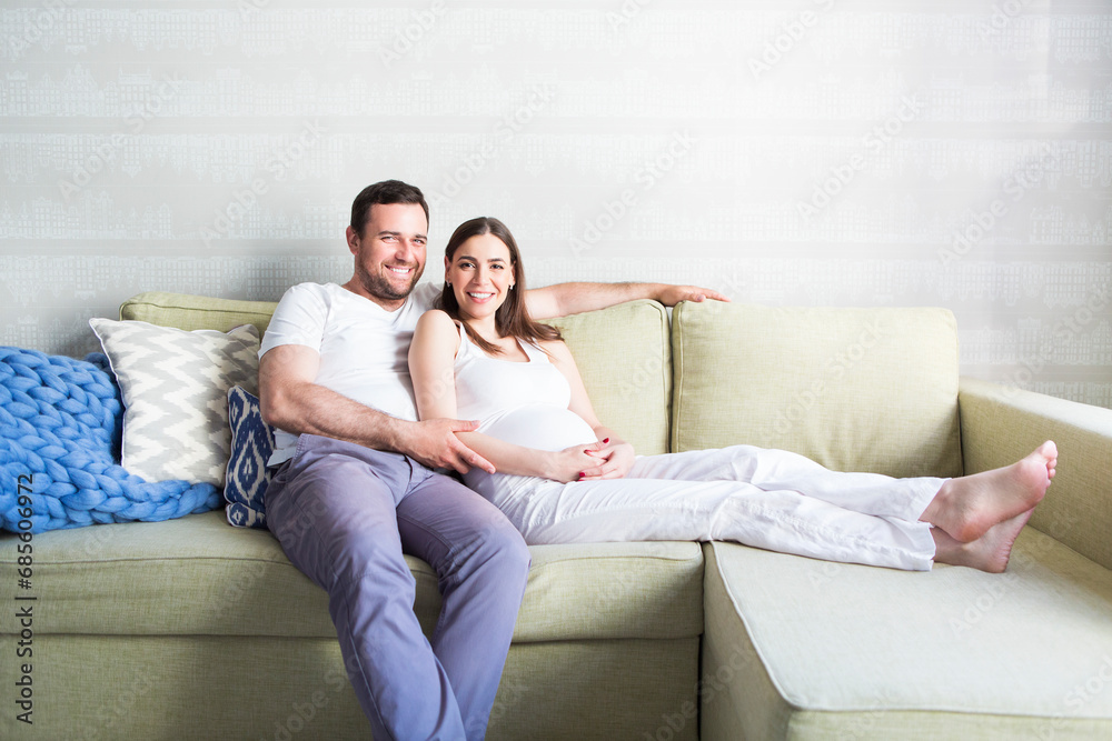 Pregnant woman and young man together indoors Pregnant woman and young man together indoors
