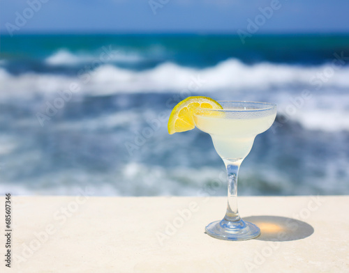 Cocktail glasses on sea background