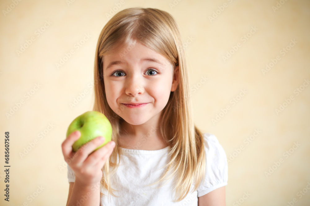 Little funny blonde girl with green apple Little funny blonde girl with green apple