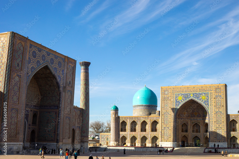 large number of tourists in historical place in Central Asia Silk Road, Registan square, Samarkand, madrasah.