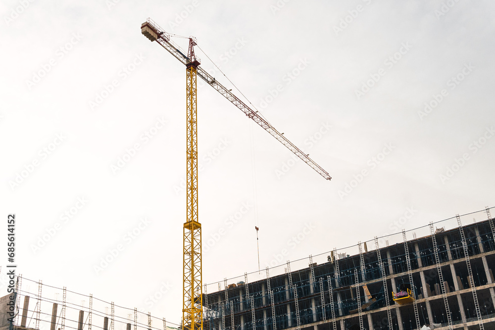 Crane working on the construction of a building. Crane working on the construction of a building.
