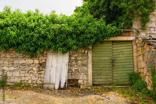 An old gate in an historic residential building in the town of Nerezisca, Brac Island, Croatia photo