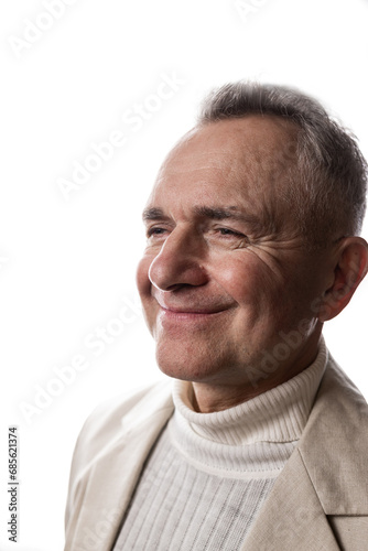Portrait of a happy senior man smiling against beige background.