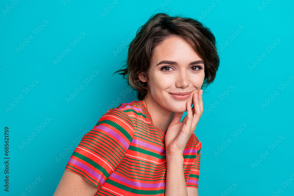 Photo of sweet cute shiny girl wear fashionable clothes arm touch cheek face isolated on cyan color background Photo of sweet cute shiny girl wear fashionable clothes arm touch cheek face isolated on cyan color background