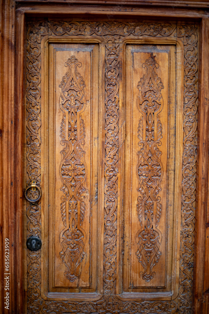 beautiful wooden carving with a ring shaped door knob, Khiva, the Khoresm agricultural oasis, Citadel. beautiful wooden carving with a ring shaped door knob, Khiva, the Khoresm agricultural oasis, Citadel.