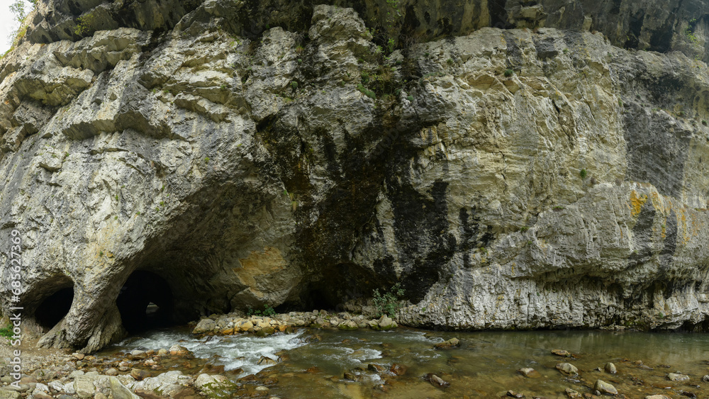 A river eroded a stone wall transforming it into a tunnel. Sohodol gorges are full of unexplored caves digged into the mountain. Carpathia, Romania. 