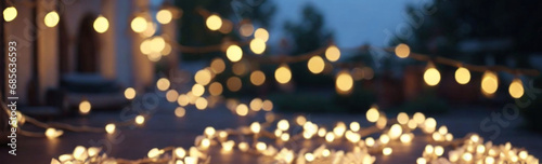 Glowing garland, evening festive atmosphere. Night lights. Banner, bokeh effect.