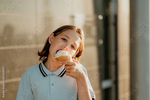 Girl enjoying ice cream cone in sunlight photo