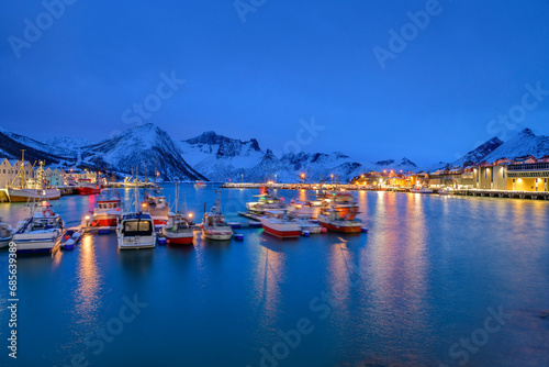 Norway, Troms og Finnmark, Husoy, Long exposure of remote fishing village during Polar night photo