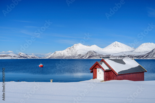 Norway, Troms og Finnmark, Secluded hut on shore of Nordfjord photo