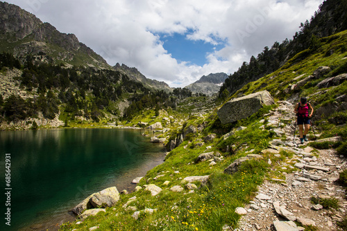 Young hiker girl summit to Ratera Peak in Aiguestortes and Sant Maurici National Park  Spain