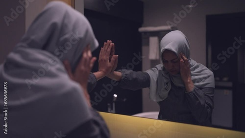 A hijab-wearing woman regrets her life after falling into deep debt and being unable to make ends meet. photo