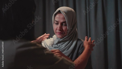 A hijab-wearing woman cries, heartbroken, and embraces gratitude for the support. show love Hope support for recovery comes soon.