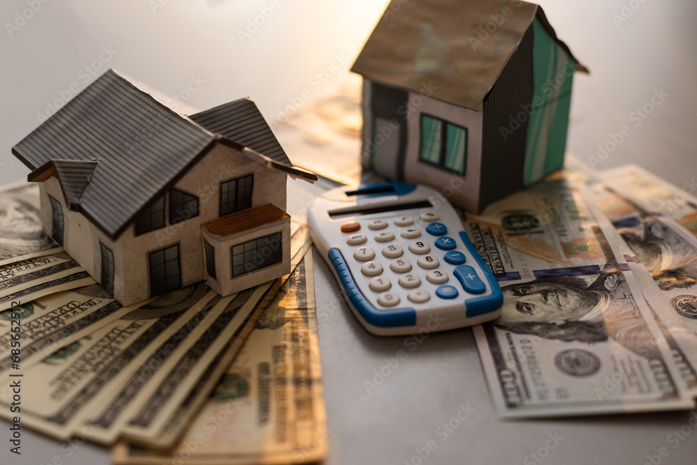 money and house model with calculator on table. money and house model with calculator on table.