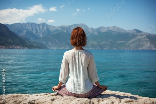 Serene woman practicing yoga at the seashore with a captivating ocean view in the background