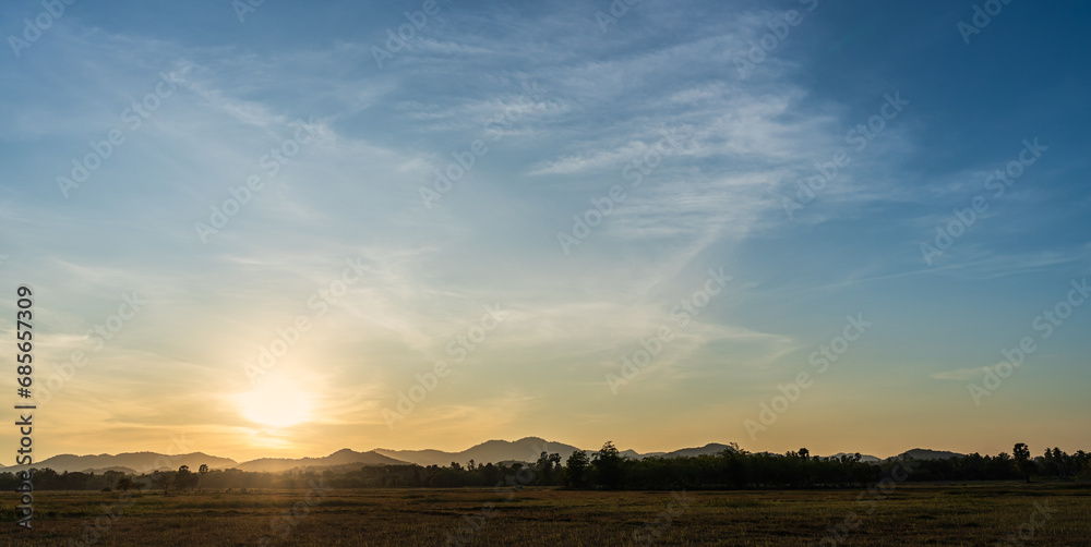 sunset sky in the evening over the field and hill end of day