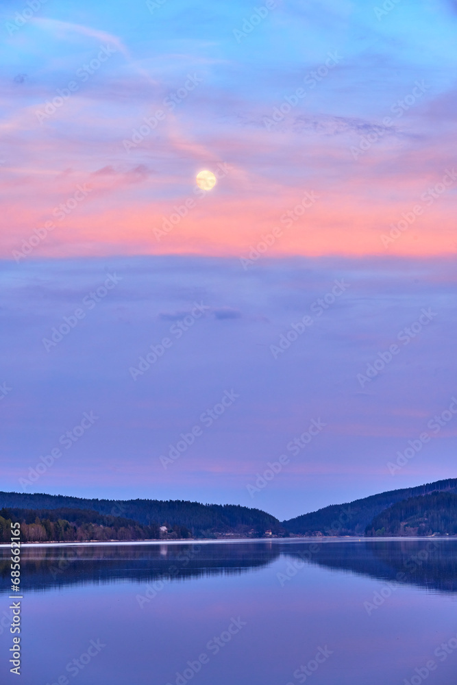 Moon over a lake in the black forest