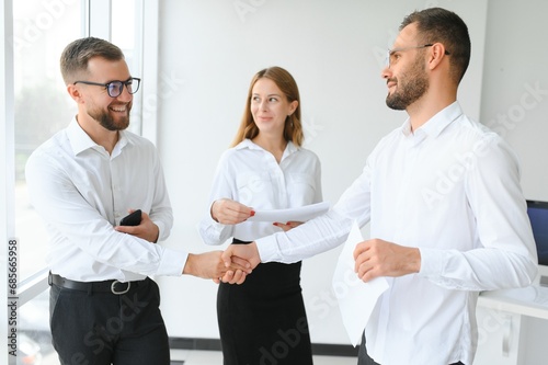 Business people stand on the background of the office corridor