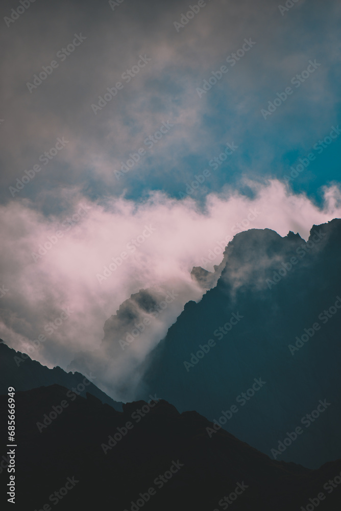 Amazing landscape in Fagaras mountains with spectacular white clouds and blue sky in Romania