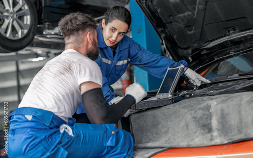 Car technician use computerized diagnostic to analyze, fix, repair engine, ensuring top performance