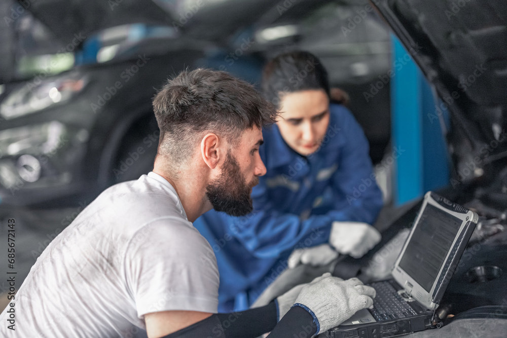 Car technician use computerized diagnostic to analyze, fix, repair engine, ensuring top performance Car technician use computerized diagnostic to analyze, fix, repair engine, ensuring top performance